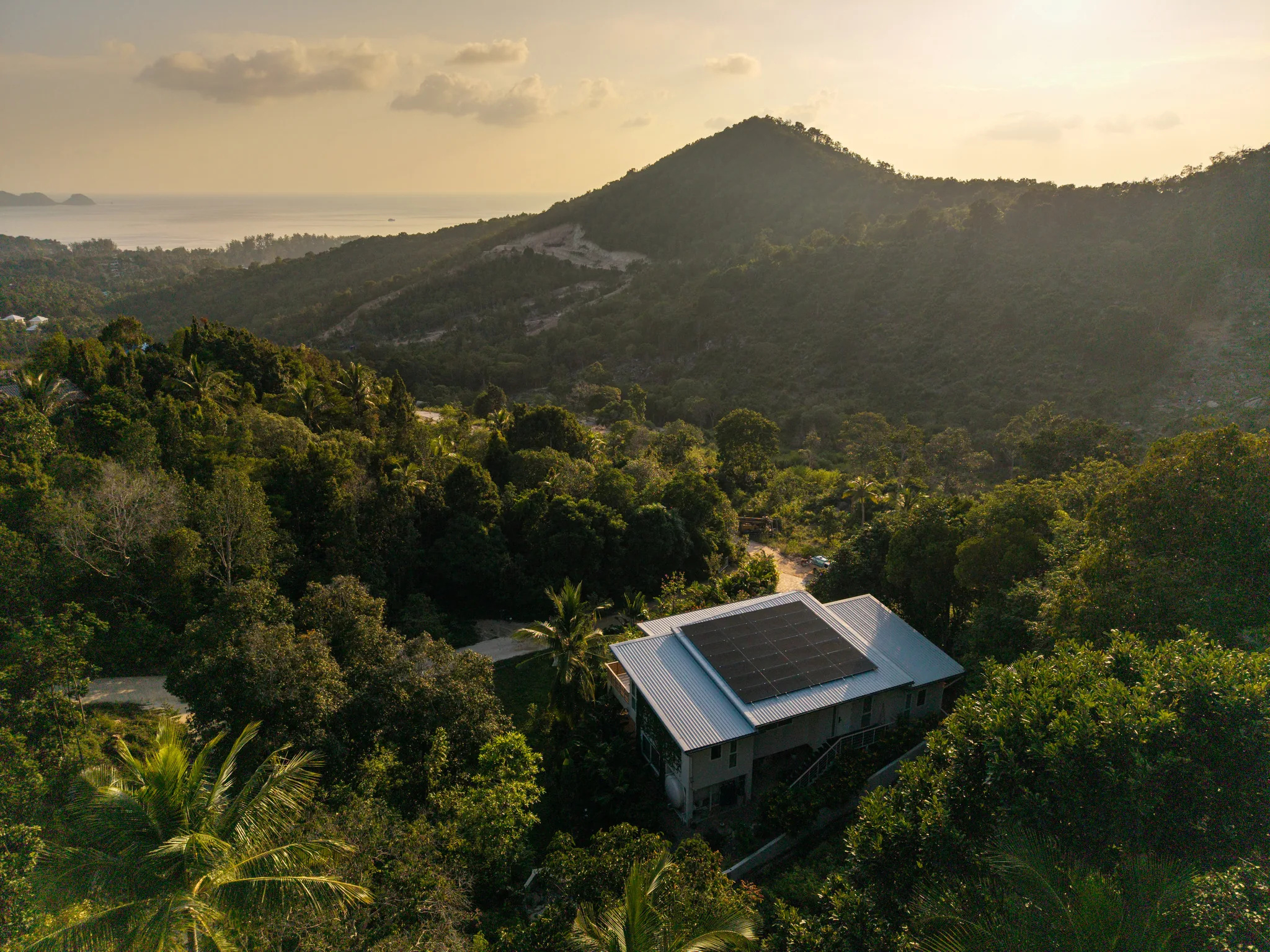 Aerial sunset view over Stella Marina Villa towards the sea