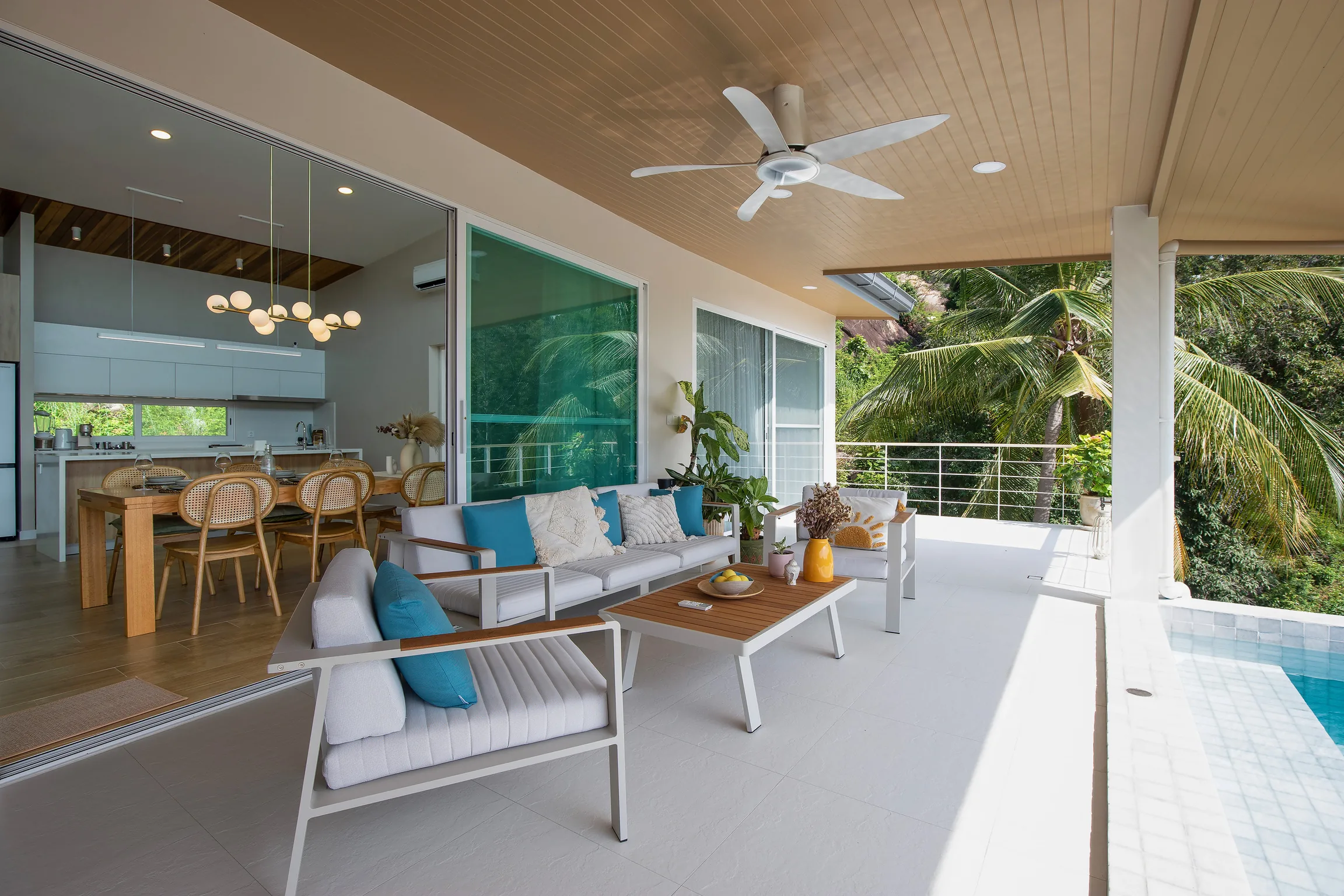 Covered terrace lounge opening into the villa
