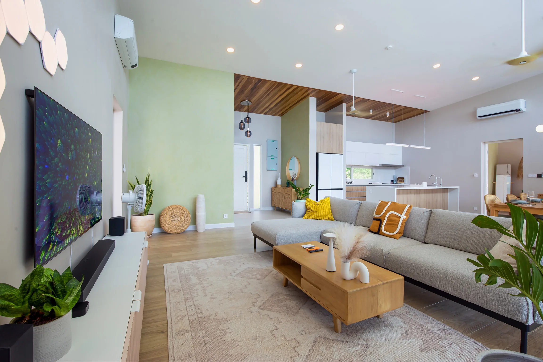 Open-plan living room with OLED TV and L-shaped sofa