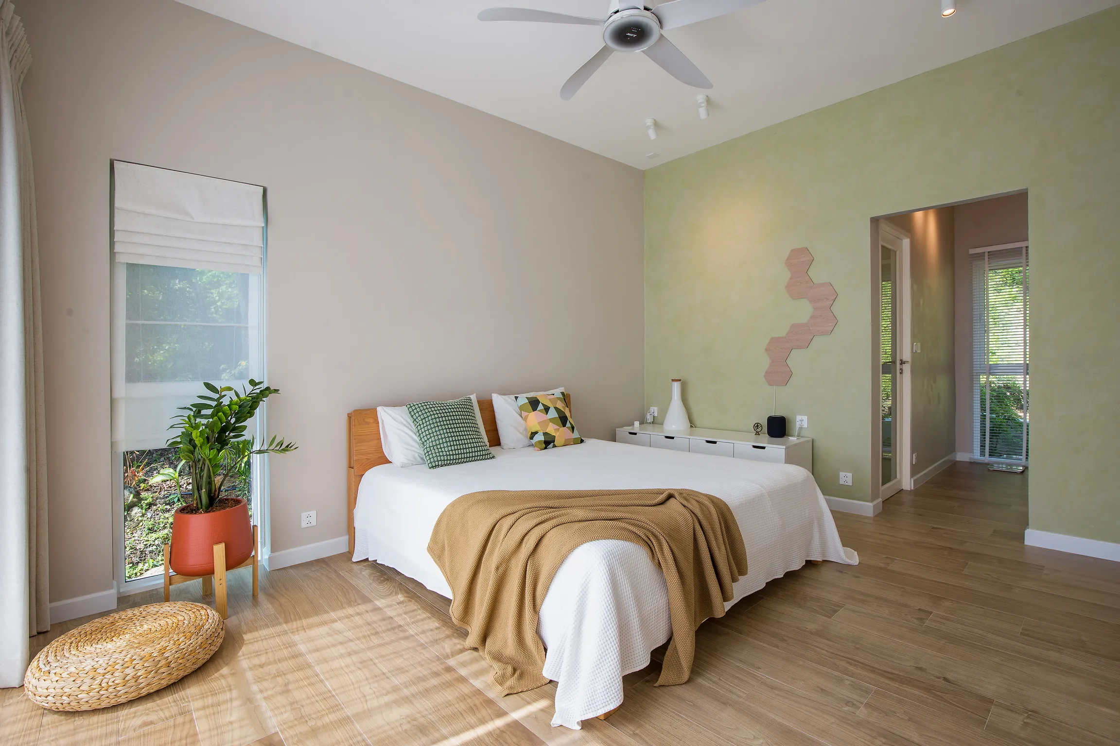 West Bedroom with king bed, armchair and walk-in wardrobe