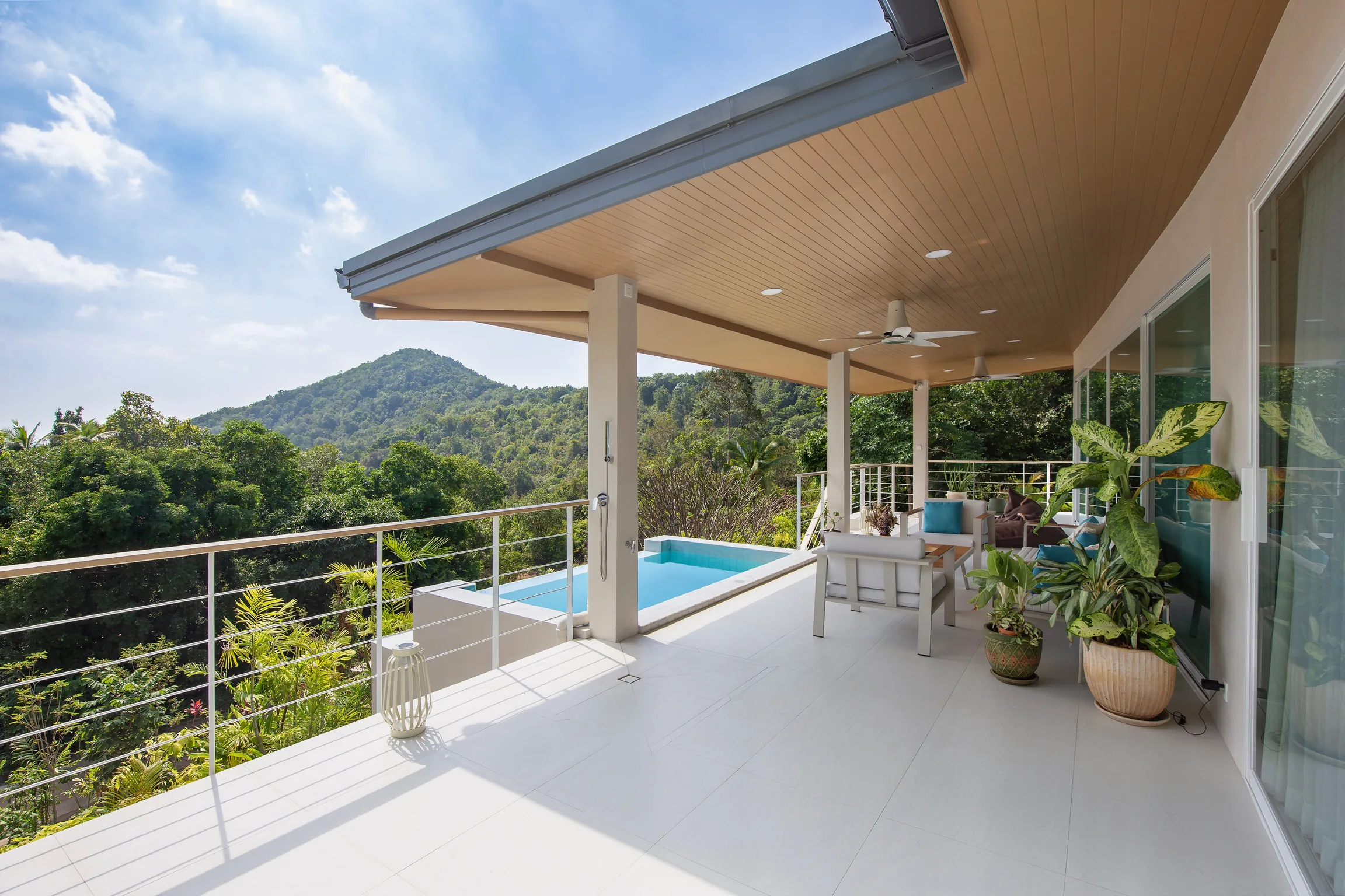 Covered terrace and suspended saltwater pool overlooking jungle hills